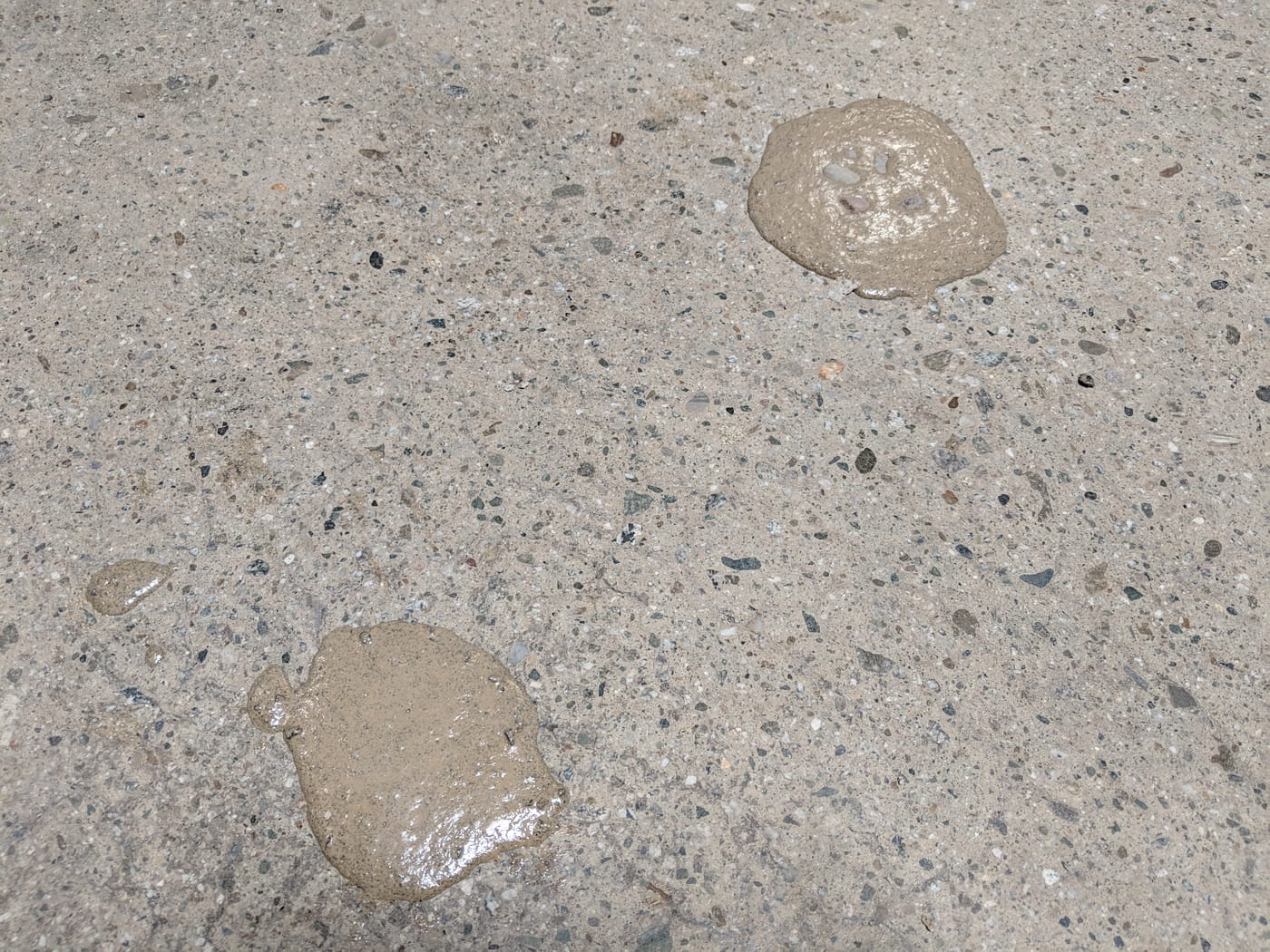 Slightly overfilled mixed material installed into surface spalls