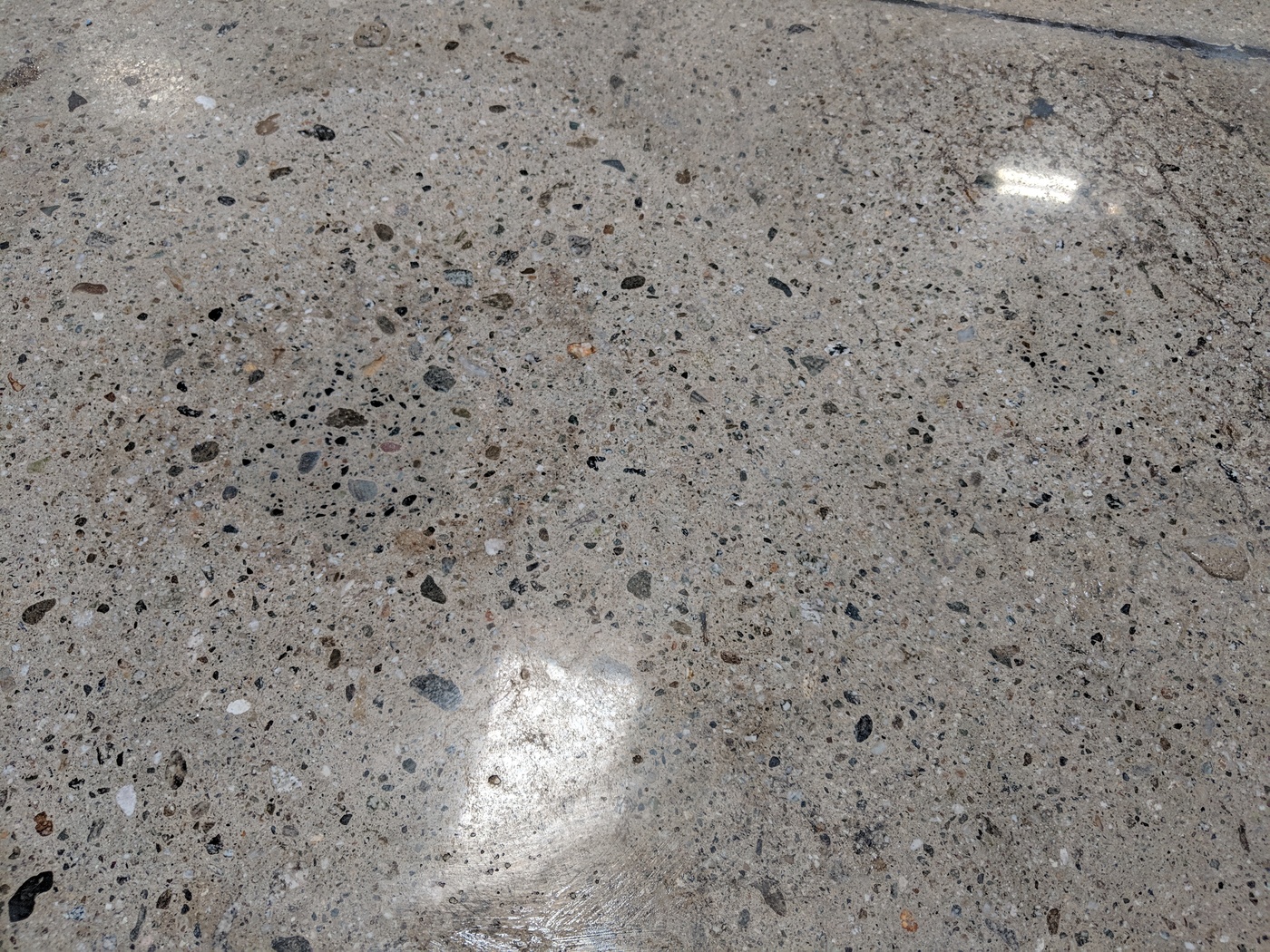 Filled spalls ground flush to the surface and polished