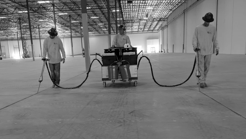 3 workers using HTS Super Pump in a large warehouse
