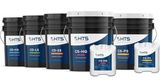 Several black and white industrial buckets and smaller containers with blue and white labels, displaying various types of HTS concrete densifiers.