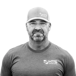 black and white photo of a smiling HTS employee named Pat