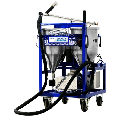 Industrial blasting machine with twin hoppers on a blue frame, equipped with hoses and nozzles, isolated on a white background.