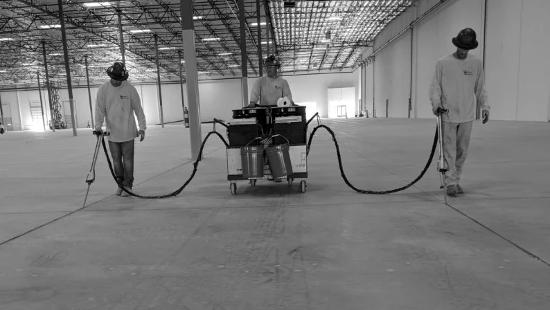 3 workers using HTS Super Pump in a large warehouse