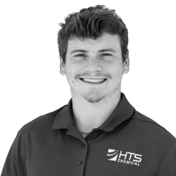 A smiling young man wearing a dark polo shirt with the logo "HTS Chemical" on it. He has short, tousled hair and is posed against a plain background.