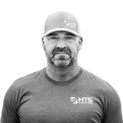 black and white photo of a smiling HTS employee named Pat